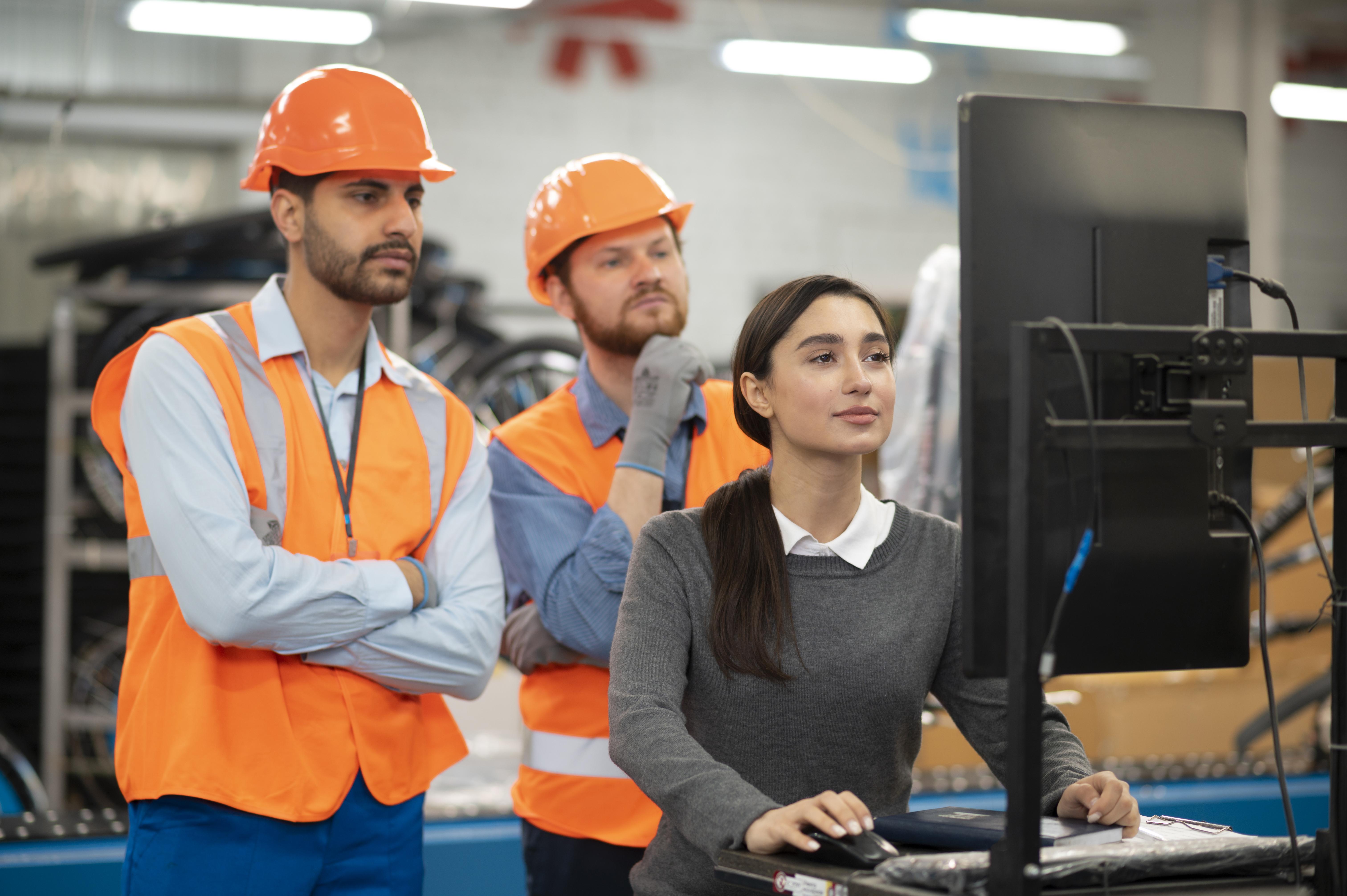 Woman presenting on screen to two crew members, illustrating our crew management services