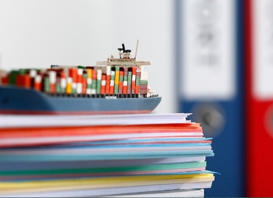 Vessel on documents symbolizing ship registration